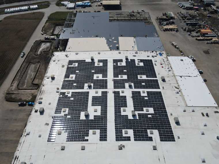 Aerial view of a commercial rooftop solar array
