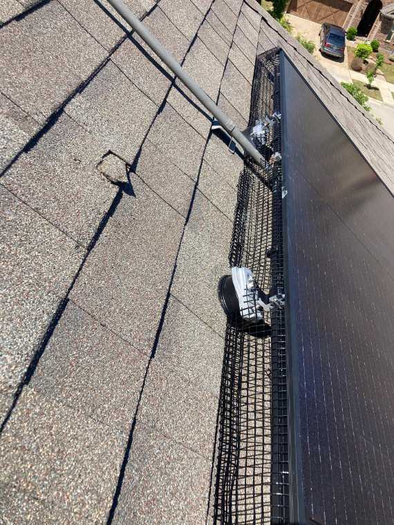 Critter guard mesh installed along a solar array