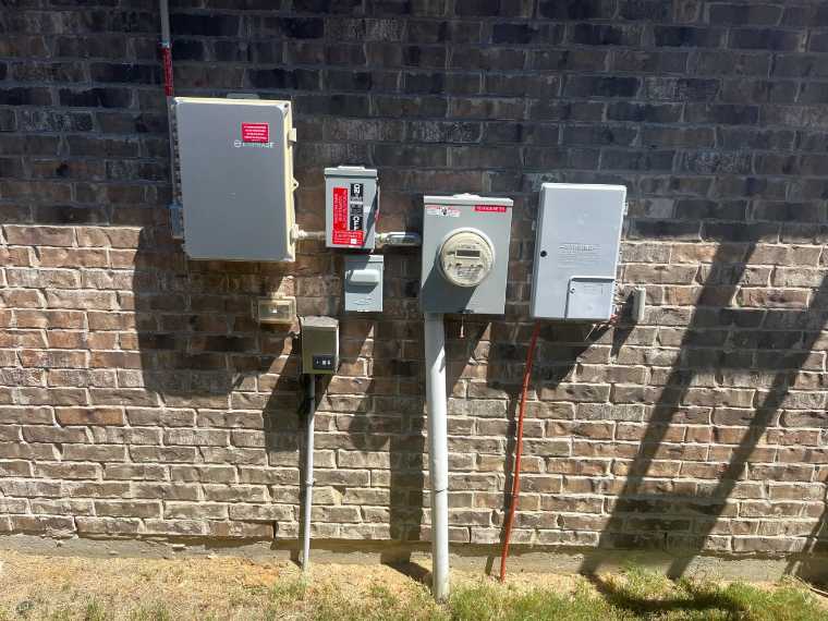 Enphase equipment and disconnect on a brick wall